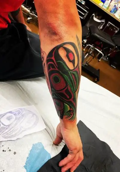 Black, Red and Green Tribe Forearm Tattoo