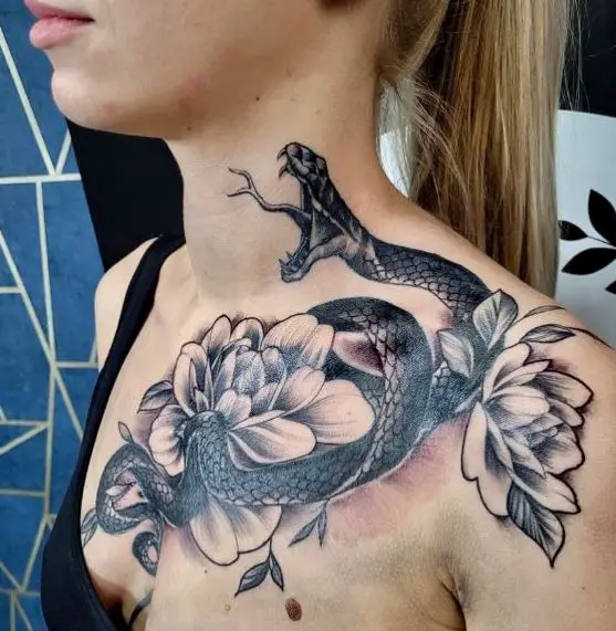 Flowers and Aggressive Snake Chest Tattoo