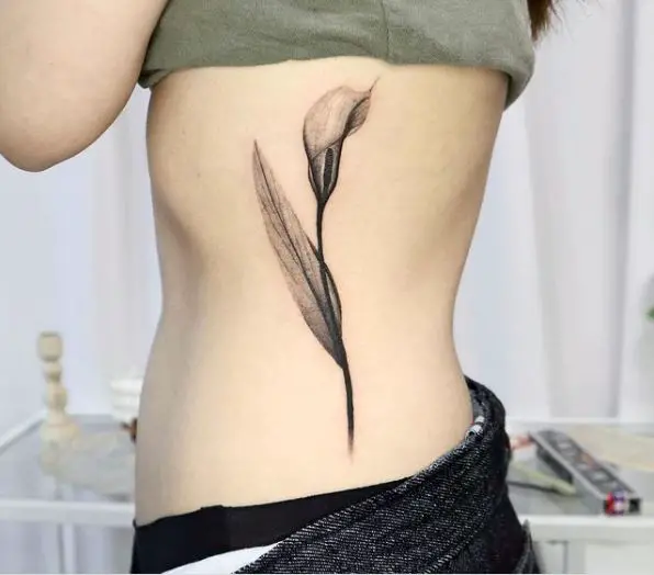 Grey Ink Calla Lily Rib Tattoo