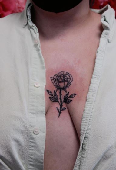 Small Grey Colored Rose Sternum Tattoo