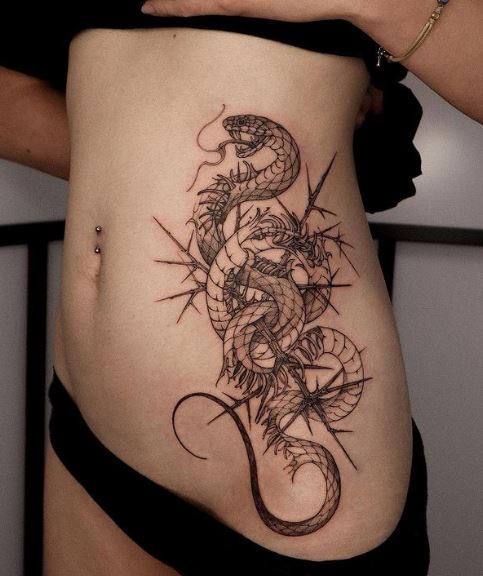 Snake Pricked with Thorns Ribs Tattoo