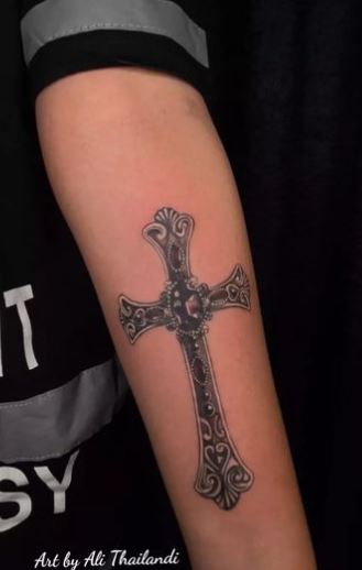 Grey Ornamented Cross Forearm Tattoo