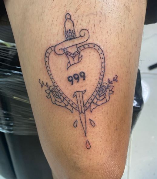 Heart Pierced with Dagger and 999 Thigh Tattoo