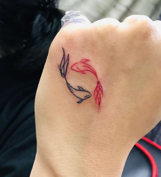 Black and Red Koi Fishes Hand Tattoo