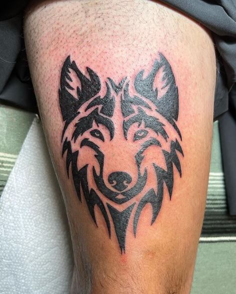 Black Tribal Wolf Thigh Tattoo