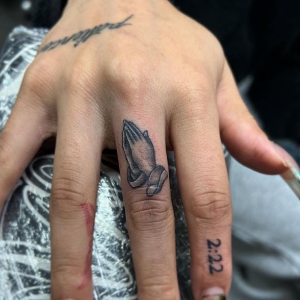 Minimalistic Praying Hands Finger Tattoo