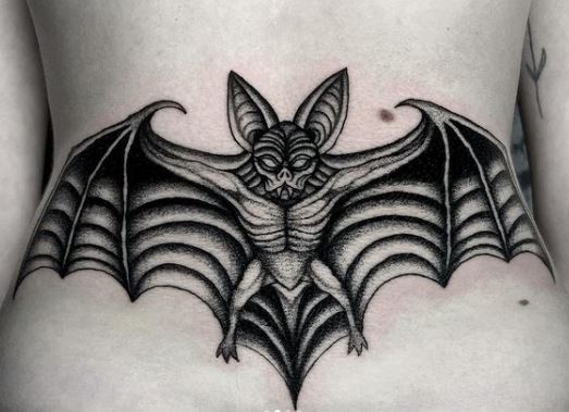 Black and Grey Gothic Bat Lower Back Tattoo