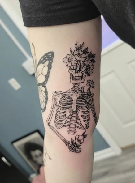 Flowers and Skeleton Inner Biceps Tattoo