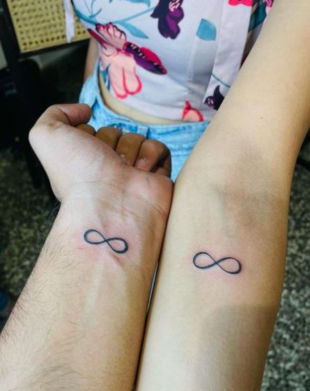 Matching Grey Infinity Symbol Forearm Tattoos