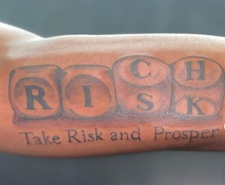 Rich Risk Script Inner Biceps Tattoo