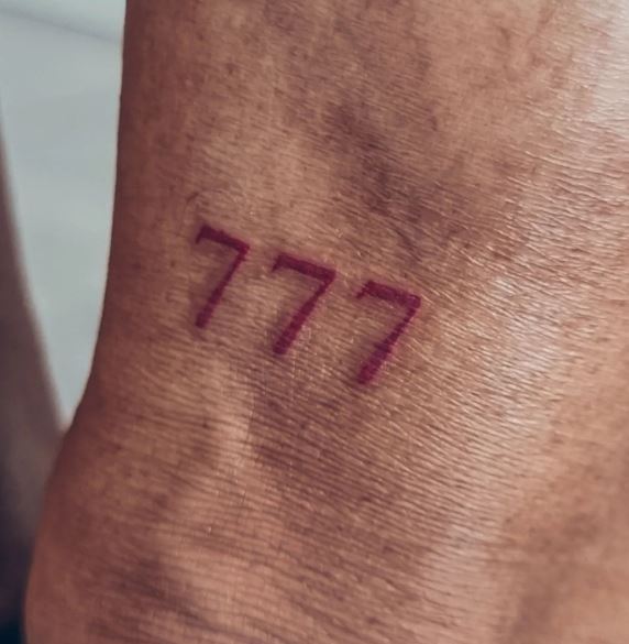 Minimalistic Red 777 Angel Number Tattoo