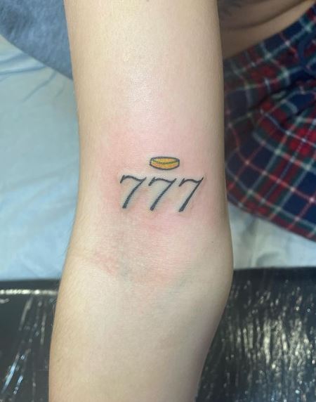 Halo and 777 Angel Number Biceps Tattoo