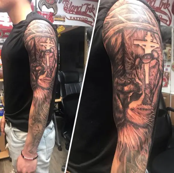 Crucifixion and Lion of Judah Full Arm Sleeve Tattoo