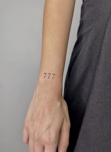 Black 777 Angel Number Wrist Tattoo