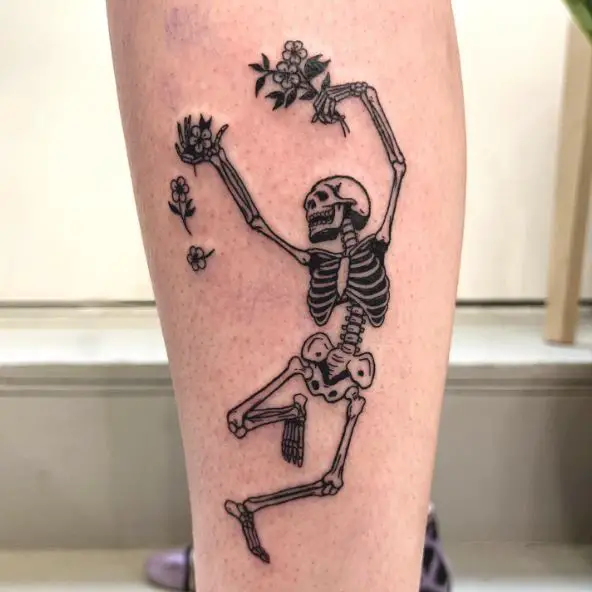 Black Work Tattoo of a Skeleton Dancing with Flowers
