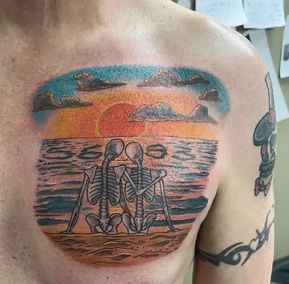 Chest Tattoo of a Skeleton Couple on the Beach