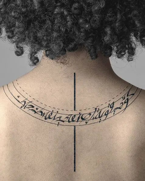 Curvy Style Arabic Phrase Tattoo