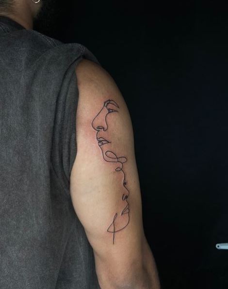 Male and Female Abstract Faces Back of Arm Tattoo