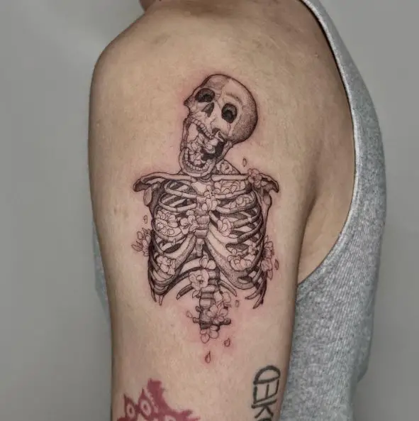 Skeleton Overgrown with Flowers Arm Tattoo