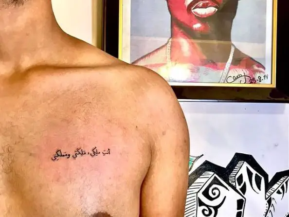 Small Arabic Phrase Chest Tattoo