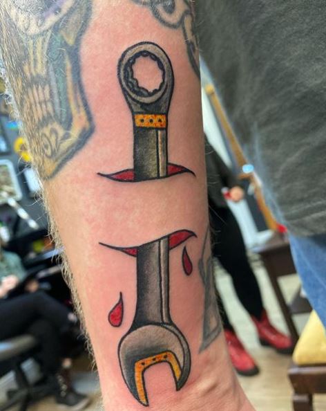 Wrench Hand Stabbing Tattoo
