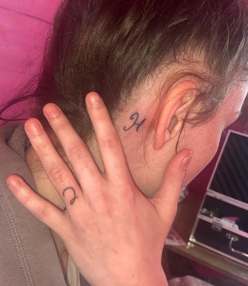 Handwritten Simple Initial Finger and Behind Ear Tattoo