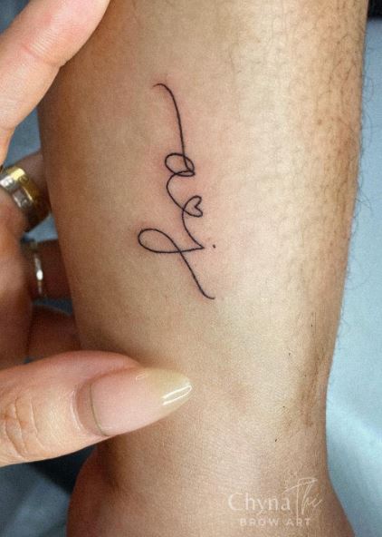 Handwritten Initial Letters AJ with Heart Forearm Tattoo