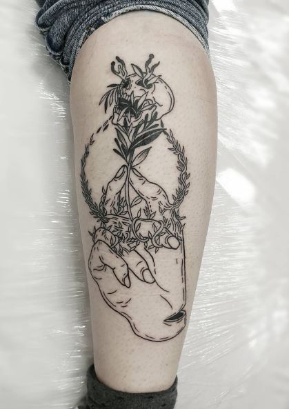 Floral Skull and Human Hand Leg Tattoo