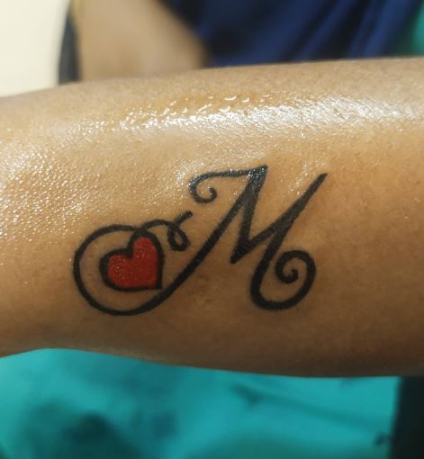Calligraphic Initial Letter M with Heart Forearm Tattoo