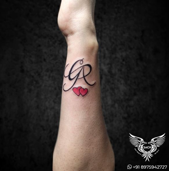 Calligraphic Initial Letters with Red Hearts Forearm Tattoo