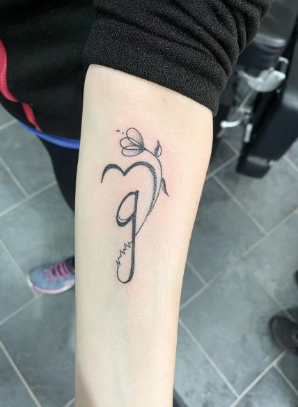 Black Initial Letter G with Flower Arm Tattoo