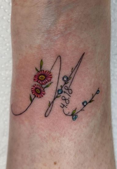 Handwritten Initial Letter M with Flowers Forearm Tattoo