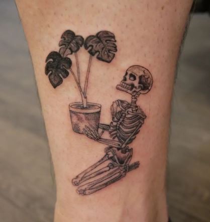 Black and Grey Plant and Skeleton Leg Tattoo