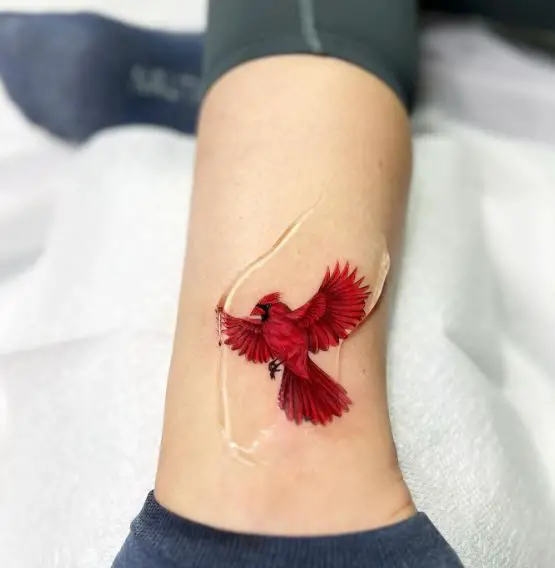 Minimalistic Red Flying Cardinal Ankle Tattoo