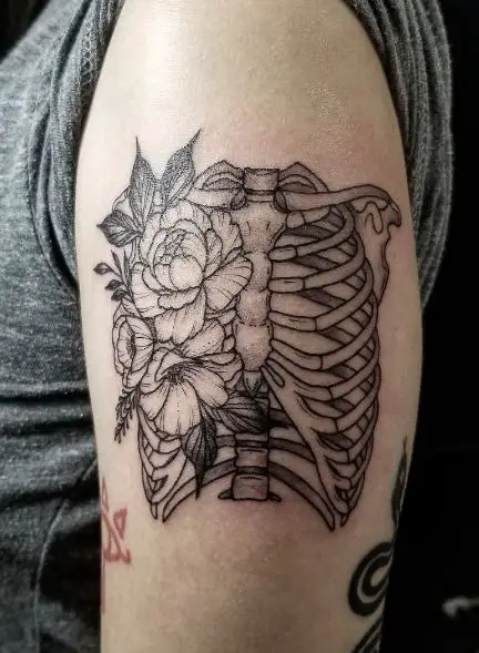 Black and Grey Flowers and Skeleton Ribcage Arm Tattoo