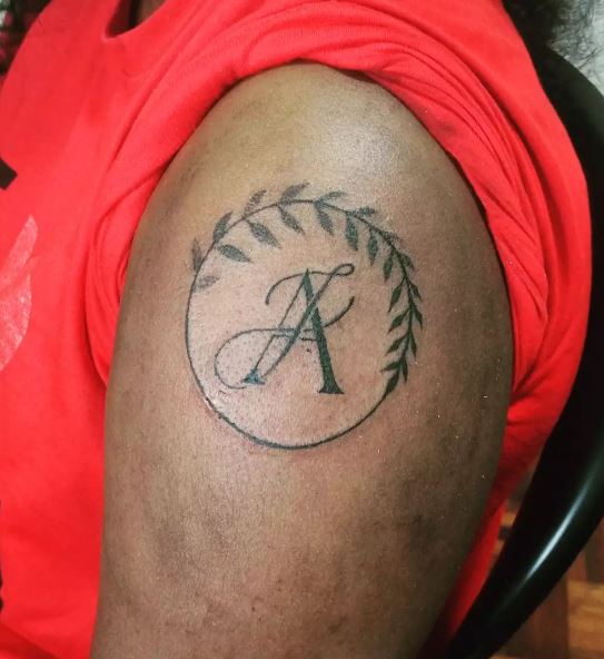Black Initial Letters AJ with Vines Shoulder Tattoo
