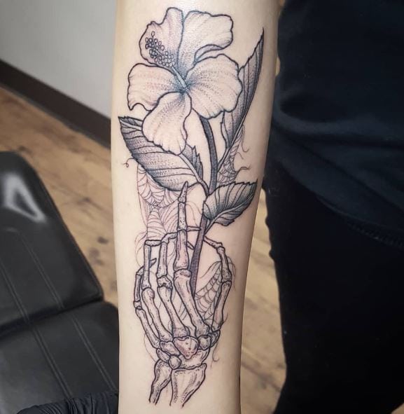Black and Grey Skeleton Hand with Hibiscus and Spider Web Arm Tattoo