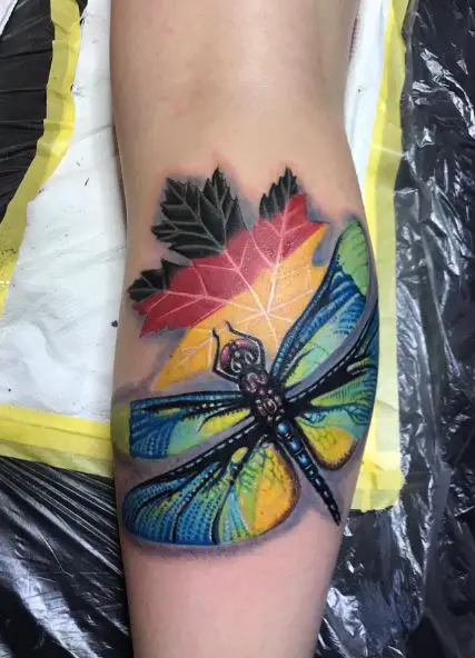Dragonfly and Maple Leaf in German Flag Colors Leg Tattoo