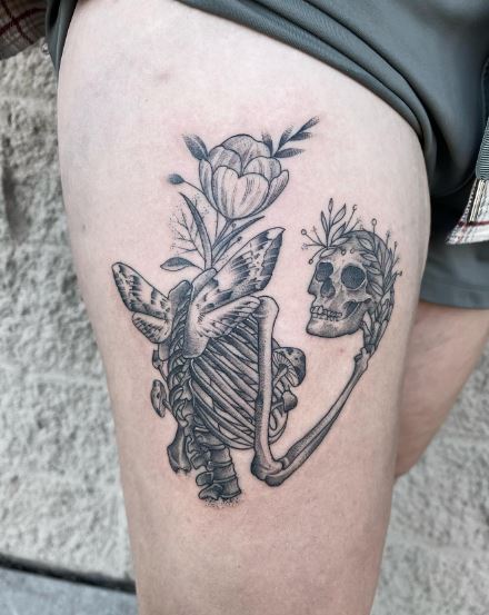 Skeleton with Flower and Moth Thigh Tattoo