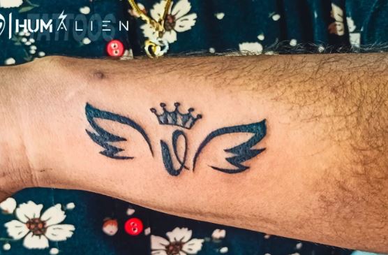 Initial Letter V with Crown and Angel Wings Forearm Tattoo