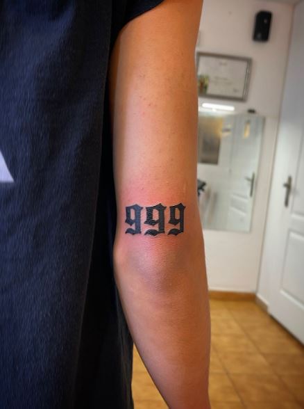 Black Number 999 Above Elbow Tattoo