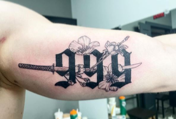 Sword and 999 with Flowers Inner Biceps Tattoo