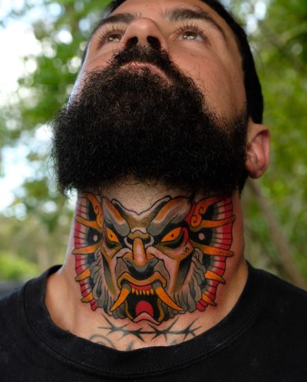 Colorful Traditional Mask Throat Tattoo