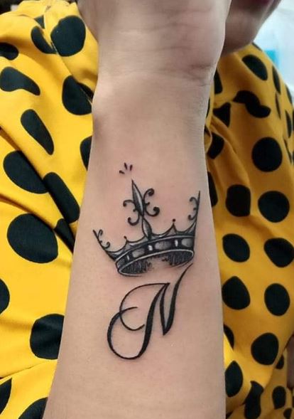 Calligraphic Initial Letter N with Crown Forearm Tattoo