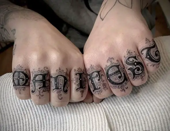Ornamented Font MANIFEST Knuckles Tattoo