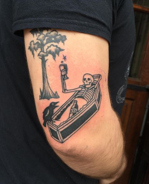 Black Skeleton in Coffin with Crow and Elixir Arm Tattoo