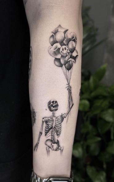 Black and Grey Balloons and Skeleton Forearm Tattoo