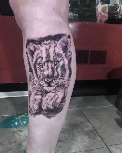 Lying Lion Cub Calf Tattoo