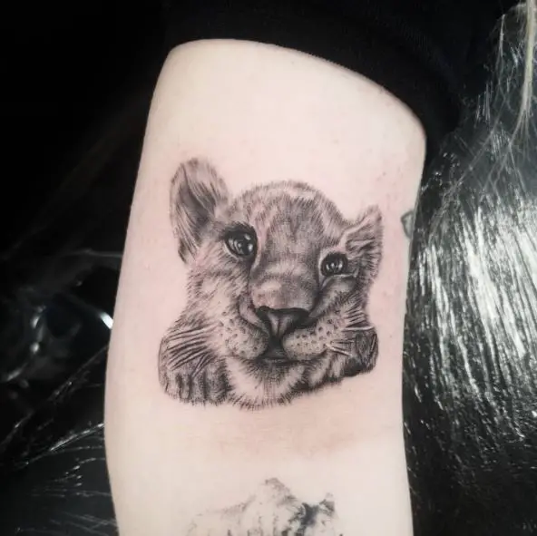 Smiling Lion Cub Arm Tattoo