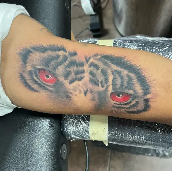 Red Tiger Eyes Inner Biceps Tattoo